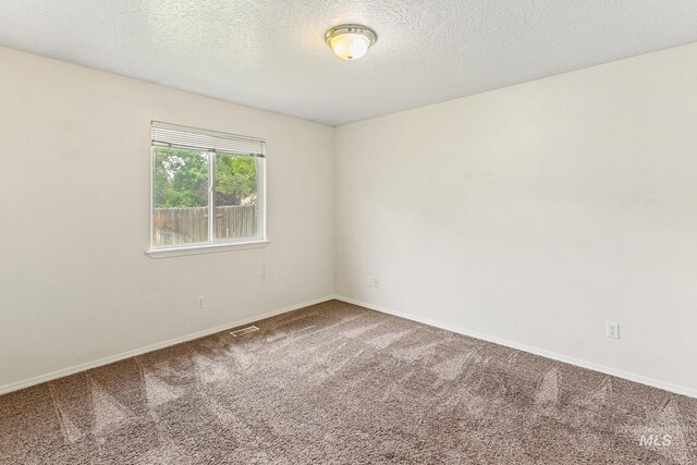 3000 E Ohio Ave, Nampa, ID 83686 - carpeted empty room with baseboards and a textured ceiling