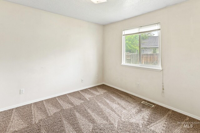 3000 E Ohio Ave, Nampa, ID 83686 - carpeted empty room with baseboards and a textured ceiling
