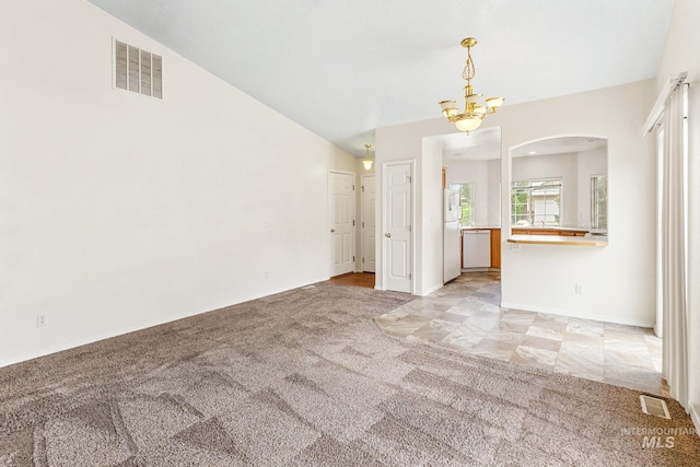 3000 E Ohio Ave, Nampa, ID 83686 - unfurnished living room with light carpet, arched walkways, lofted ceiling, a chandelier, and baseboards