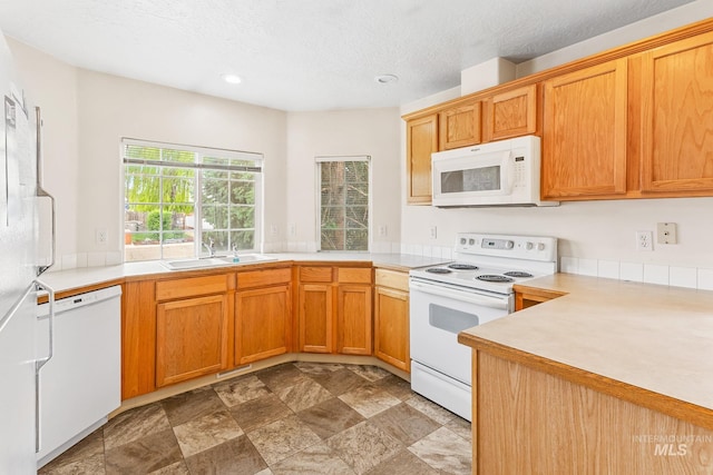 3000 E Ohio Ave, Nampa, ID 83686 - kitchen featuring white appliances, a sink, light countertops, stone finish floors, and recessed lighting