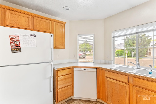 3000 E Ohio Ave, Nampa, ID 83686 - kitchen with white appliances, a sink, and light countertops