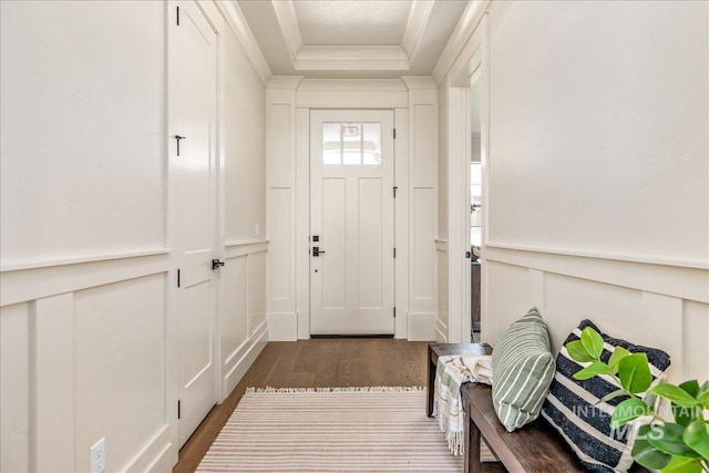 doorway to outside with dark hardwood / wood-style floors and ornamental molding