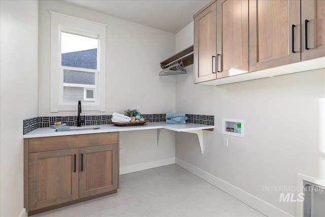 3484 W Retreat St Lot 23/6, Eagle, ID 83616 - laundry room featuring washer hookup, cabinet space, light tile patterned floors, and baseboards