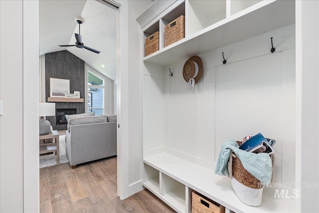 3484 W Retreat St Lot 23/6, Eagle, ID 83616 - mudroom featuring wood finished floors, ceiling fan, a tiled fireplace, and vaulted ceiling