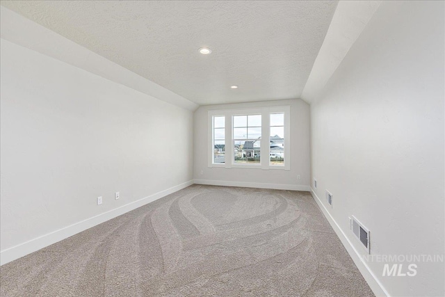 3484 W Retreat St Lot 23/6, Eagle, ID 83616 - carpeted spare room with a textured ceiling, baseboards, lofted ceiling, and recessed lighting