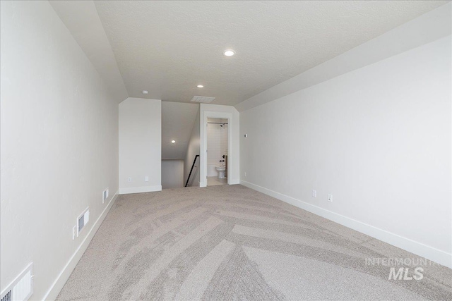 3484 W Retreat St Lot 23/6, Eagle, ID 83616 - unfurnished room with light carpet, recessed lighting, baseboards, a textured ceiling, and lofted ceiling