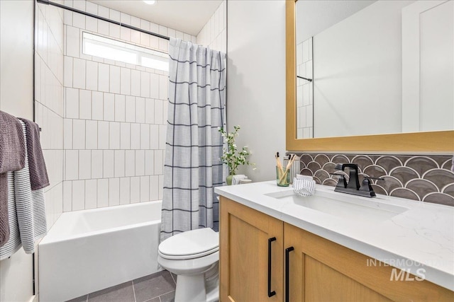 full bathroom featuring shower / bath combination with curtain, backsplash, vanity, tile patterned flooring, and toilet