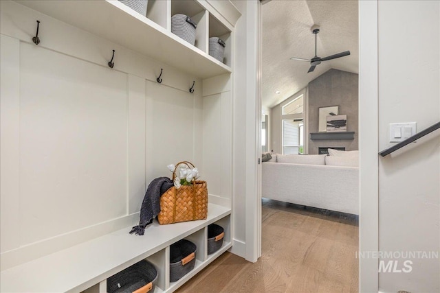 mudroom featuring a textured ceiling, hardwood / wood-style flooring, vaulted ceiling, and ceiling fan