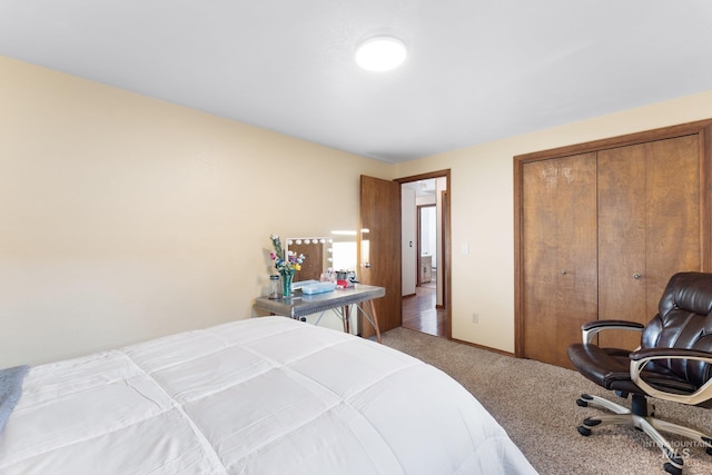 bedroom with carpet, a closet, and baseboards