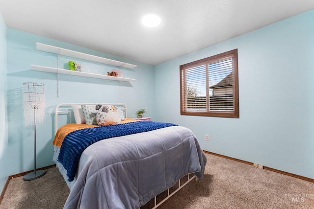 bedroom with baseboards and carpet