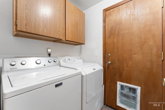 laundry area with heating unit, cabinet space, and separate washer and dryer