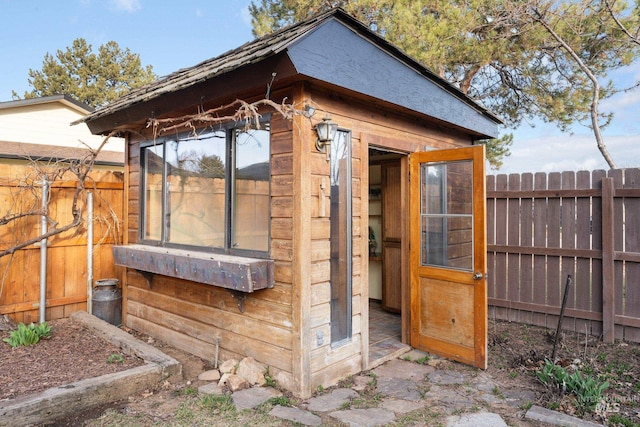 view of outbuilding with an outdoor structure and a fenced backyard