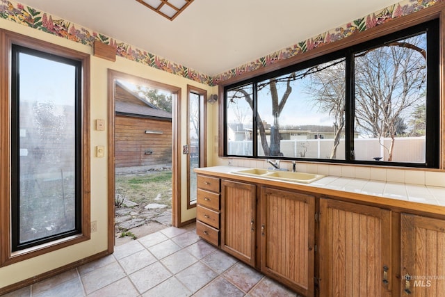 bathroom with baseboards, plenty of natural light, and vanity