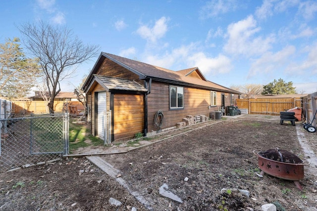 rear view of property with cooling unit and a fenced backyard