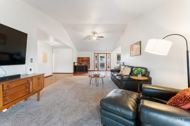 living room with ceiling fan, lofted ceiling, and wood finished floors