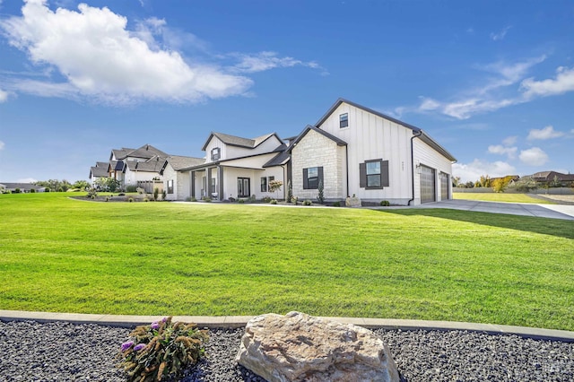 modern inspired farmhouse featuring an attached garage, concrete driveway, stone siding, board and batten siding, and a front yard