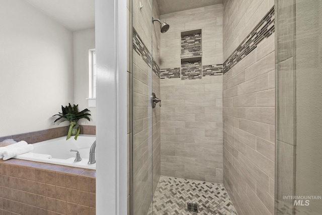 full bathroom featuring a stall shower and a bath