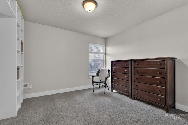 sitting room with a textured ceiling, carpet, and baseboards