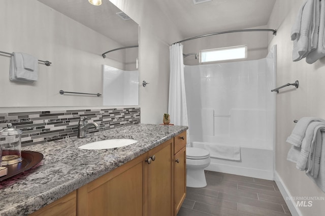 bathroom featuring toilet, visible vents, baseboards, vanity, and decorative backsplash