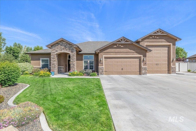 11954 W Meadowfalls Dr, Star, ID 83669 - view of front of property featuring stone siding, an attached garage, driveway, and a front yard