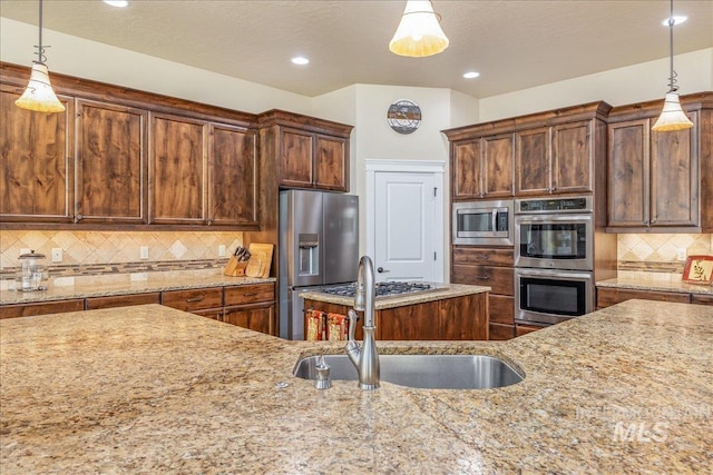 11954 W Meadowfalls Dr, Star, ID 83669 - kitchen with stainless steel appliances, light stone countertops, backsplash, decorative light fixtures, and recessed lighting