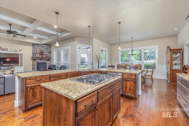 11954 W Meadowfalls Dr, Star, ID 83669 - kitchen with a kitchen island, a ceiling fan, dark wood-style floors, open floor plan, and beamed ceiling