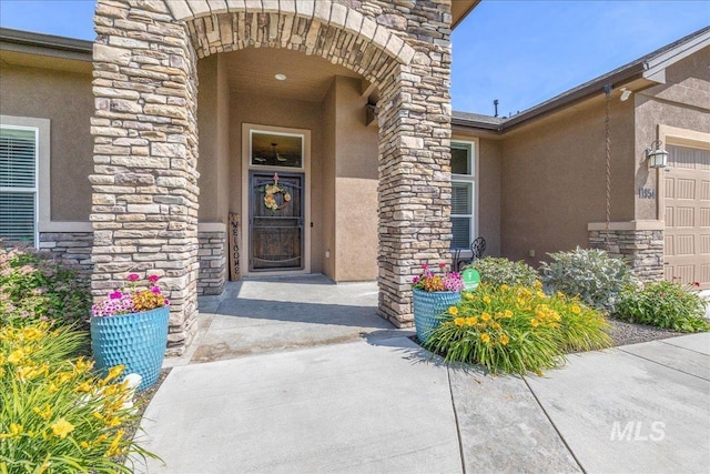 11954 W Meadowfalls Dr, Star, ID 83669 - property entrance featuring stucco siding, stone siding, and an attached garage