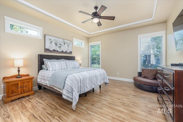 11954 W Meadowfalls Dr, Star, ID 83669 - bedroom with light wood-style floors, a raised ceiling, and a ceiling fan