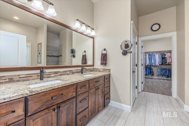 11954 W Meadowfalls Dr, Star, ID 83669 - bathroom with double vanity, backsplash, and a walk in closet