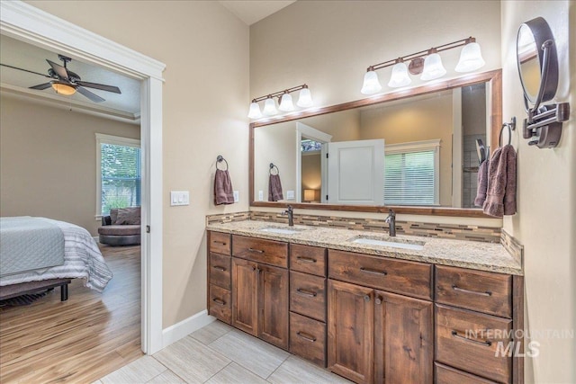 11954 W Meadowfalls Dr, Star, ID 83669 - bathroom with double vanity, connected bathroom, ceiling fan, and backsplash