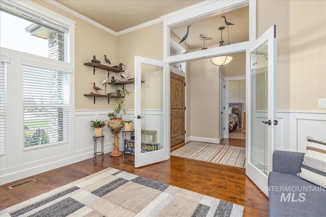 11954 W Meadowfalls Dr, Star, ID 83669 - interior space with french doors, wood finished floors, crown molding, a decorative wall, and a wainscoted wall