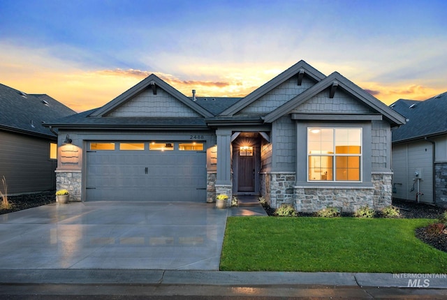 craftsman-style home featuring a lawn and a garage