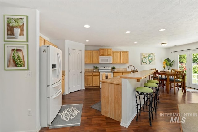 4456 N Weston Ave, Meridian, ID 83646 - kitchen featuring white appliances, a kitchen breakfast bar, light countertops, recessed lighting, and light brown cabinetry