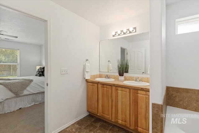 4456 N Weston Ave, Meridian, ID 83646 - ensuite bathroom featuring healthy amount of natural light, double vanity, a tub, and baseboards