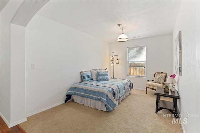4456 N Weston Ave, Meridian, ID 83646 - bedroom with light colored carpet, baseboards, and arched walkways