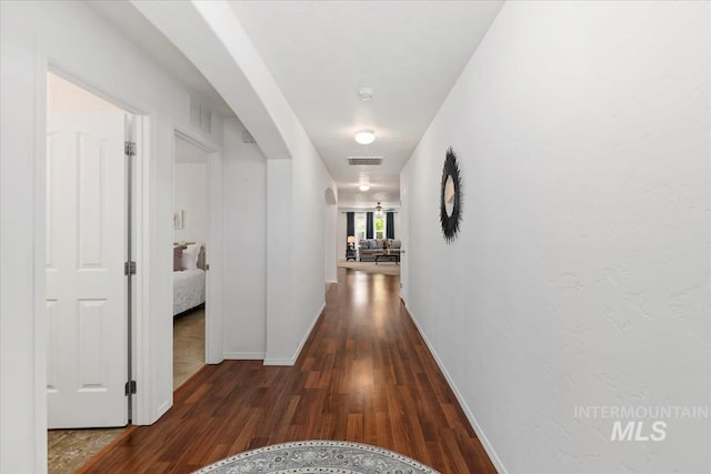 4456 N Weston Ave, Meridian, ID 83646 - corridor featuring arched walkways, wood finished floors, and baseboards