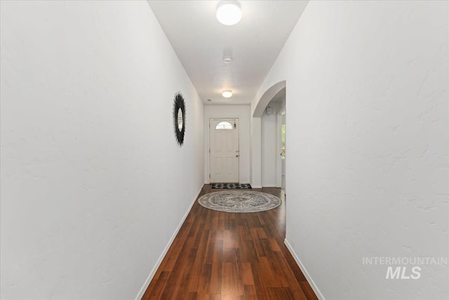 4456 N Weston Ave, Meridian, ID 83646 - hallway featuring arched walkways, baseboards, and wood finished floors