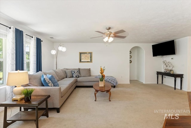 4456 N Weston Ave, Meridian, ID 83646 - living area with arched walkways, ceiling fan, and light carpet