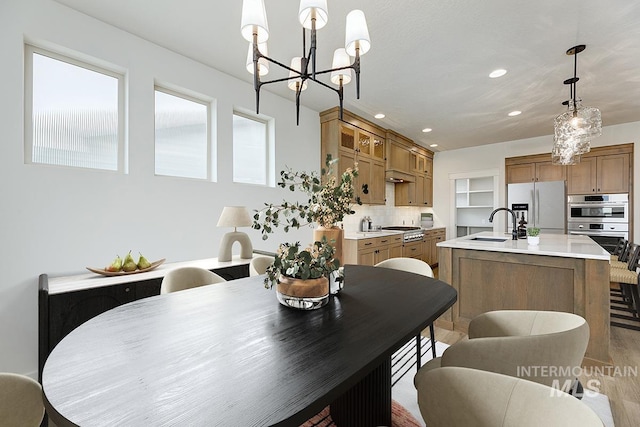 6998 S Tindaris Ave, Meridian, ID 83642 - dining room with a chandelier, light wood-style flooring, and recessed lighting