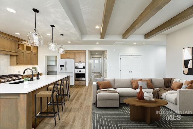 6998 S Tindaris Ave, Meridian, ID 83642 - living room featuring recessed lighting, beam ceiling, and light wood-style flooring