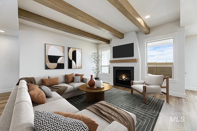 6998 S Tindaris Ave, Meridian, ID 83642 - living area featuring a glass covered fireplace, light wood-type flooring, beamed ceiling, and recessed lighting