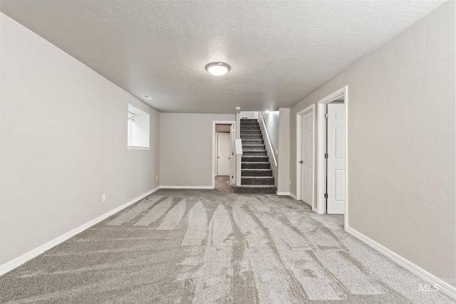 2155 N Fairmeadow Dr, Boise, ID 83704 - basement featuring a textured ceiling, carpet flooring, stairway, and baseboards