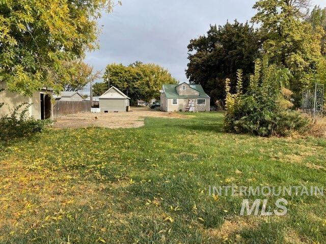 view of yard with an outdoor structure and fence