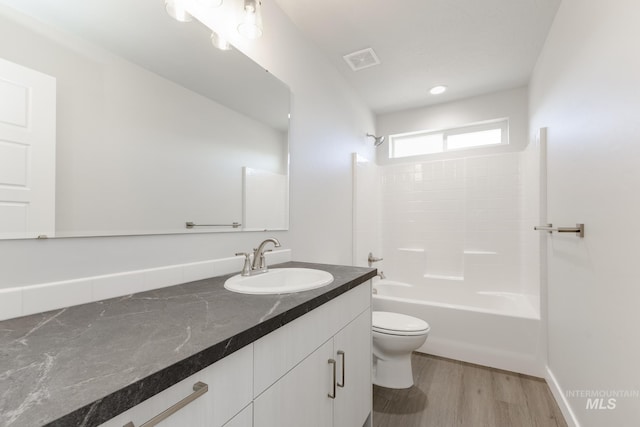 5289 E Grizzly St, Nampa, ID 83687 - full bath with toilet, vanity, tub / shower combination, and wood finished floors