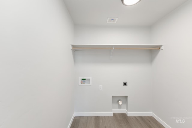 5289 E Grizzly St, Nampa, ID 83687 - laundry area with washer hookup, electric dryer hookup, wood finished floors, and baseboards