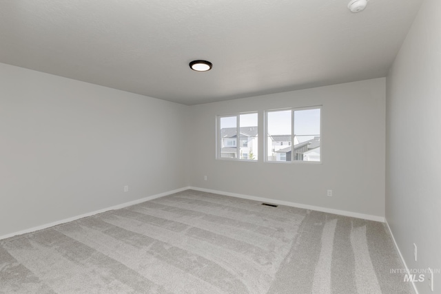 5289 E Grizzly St, Nampa, ID 83687 - spare room featuring light colored carpet, baseboards, and a smoke detector