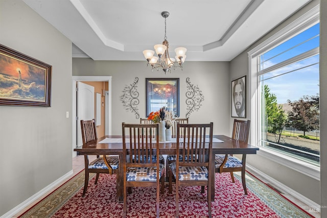 2570 Reservoir Rd, Clarkston, WA 99403 - dining area with a chandelier, baseboards, and a raised ceiling