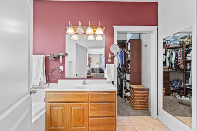 2570 Reservoir Rd, Clarkston, WA 99403 - bathroom featuring vanity, tile patterned flooring, a walk in closet, and a tub to relax in