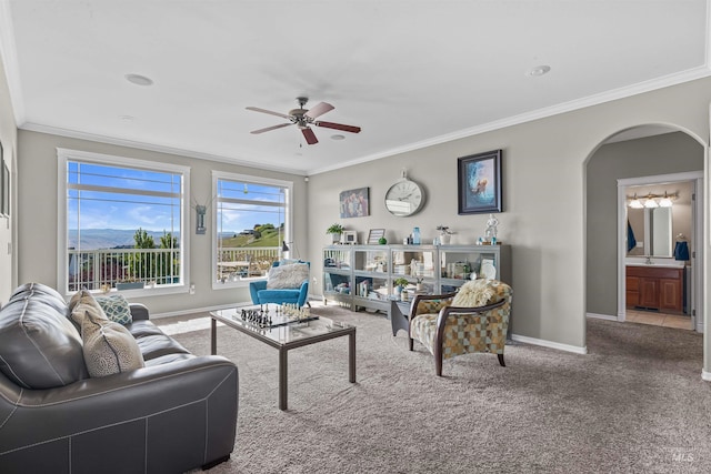 2570 Reservoir Rd, Clarkston, WA 99403 - living room featuring ceiling fan, baseboards, arched walkways, crown molding, and carpet flooring