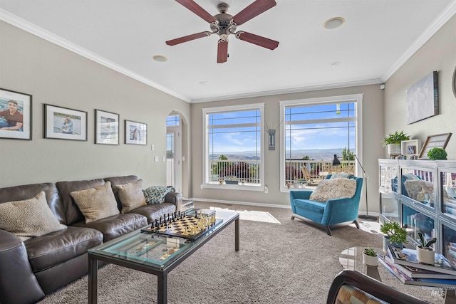 2570 Reservoir Rd, Clarkston, WA 99403 - carpeted living room featuring arched walkways, crown molding, a ceiling fan, and baseboards
